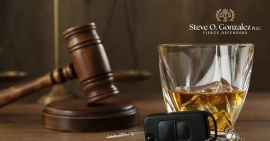 closeup of a gavel, car keys, and an alcoholic drink
